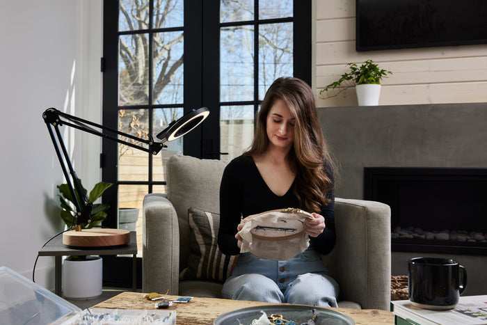 Black adjustable Canvas LED desk lamp with wooden base  lighting a artist and her creation